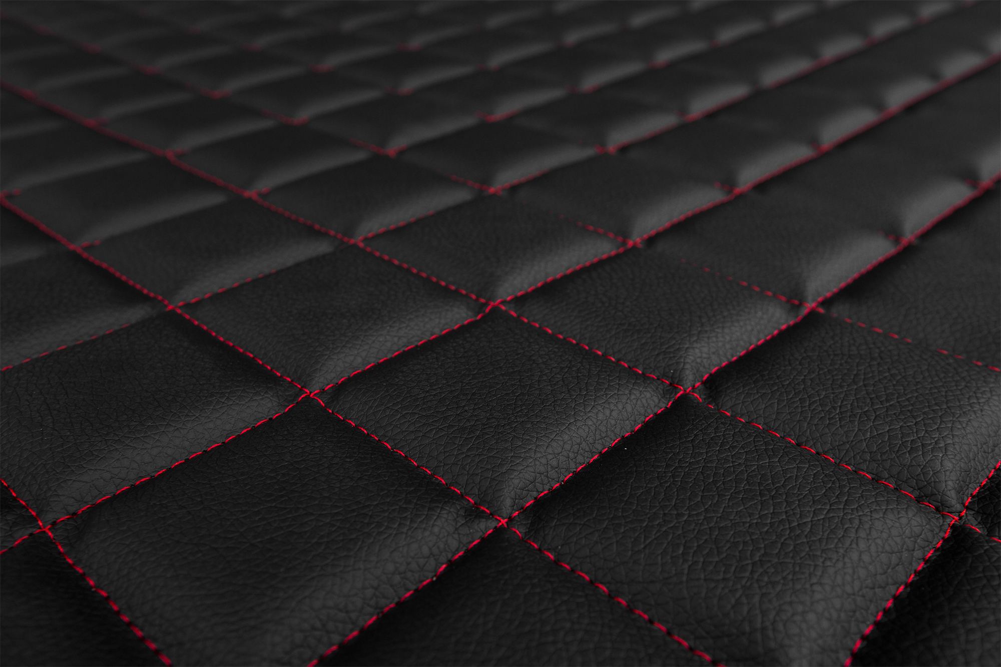 Détail de la surface et du matelassage des housses ELEGANCE Q : Noir et rouge